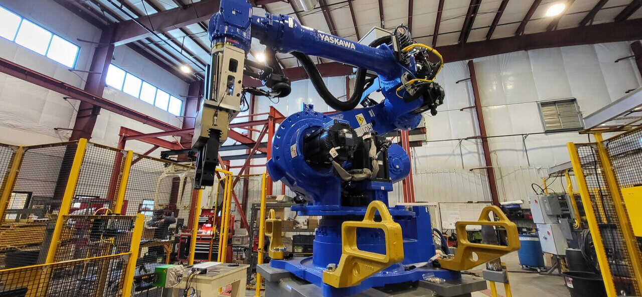 Yaskawa-Motoman blue robot for machine tending project within fenced perimeter